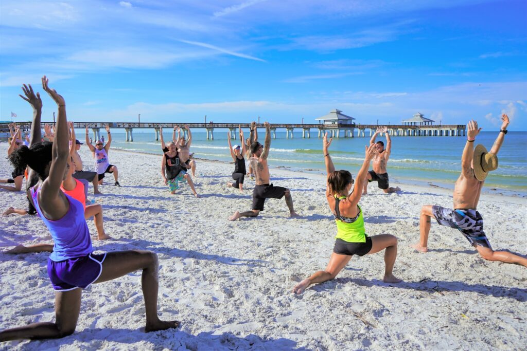 people exercising on seashore during daytime