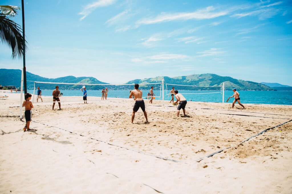 men playing volleyball on sand